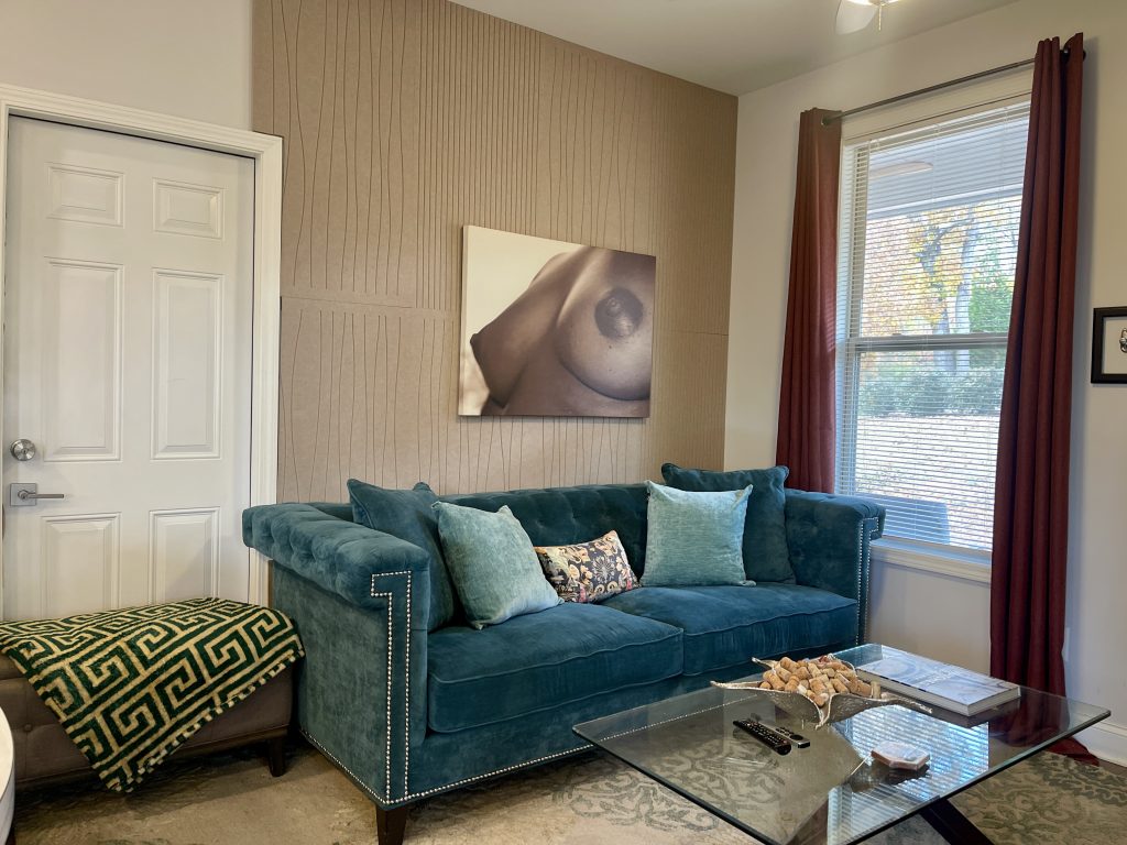 Coach with a naked bust of a woman hanging on the wall.